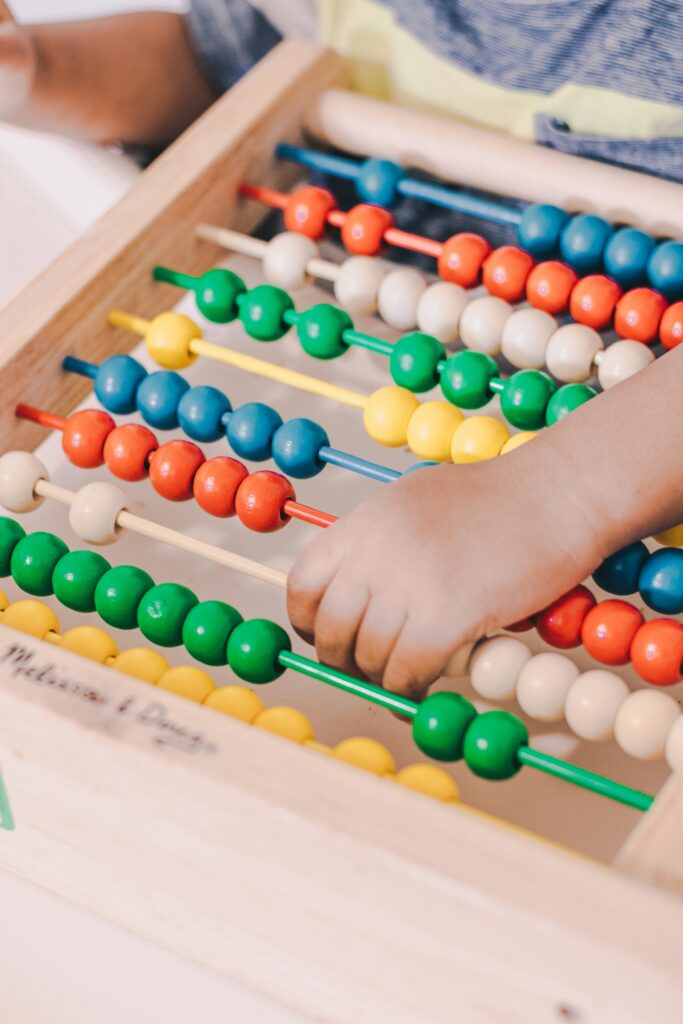 Child holding an abacus