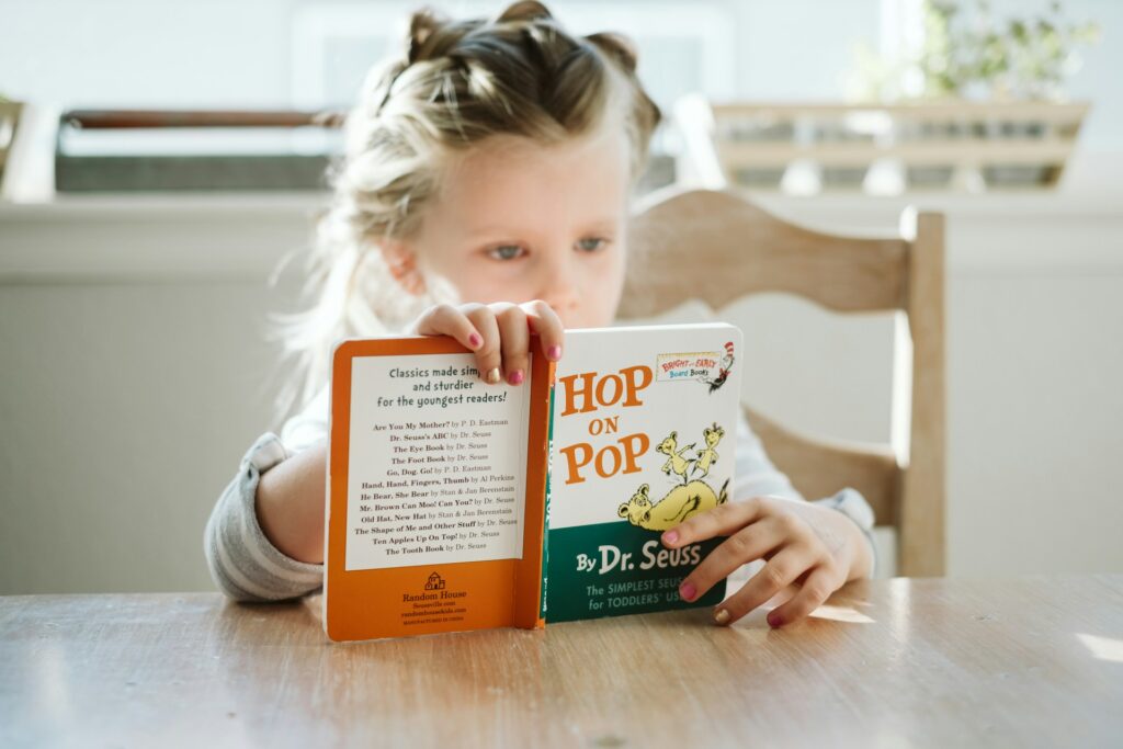 Girl reading a Dr. Seuss book